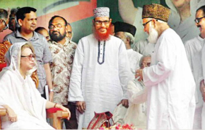 In this file photo, incarcerated BNP chief Khaleda Zia, left, seen sharing a light moment with members of her alliance partner, then Jamaat-e-Islami chief, Matiur Rahman Nizami, right, and one of the top leaders back then, Delwar Hossain Sayeedi, centre, at a rally in Dhaka Courtesy. Image source - archive.dhakatribune.com