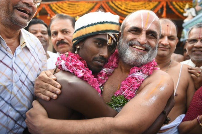 Representative image of Chilkur Balaji temple priest who had carried a Dalit youth on his shoulders in September 2021, to send a message against the notions of discrimination, image via UCA news copy)