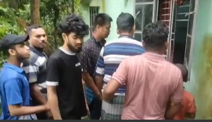 Image: Locals gathered at the home where the couple were found murdered