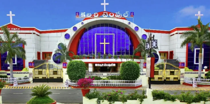 Image of a Hindu temple with vibrant colors and traditional architecture, featuring a large arched e.