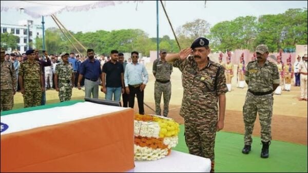 Saluting military personnel at a memorial ceremony in Bijapur, Odisha.