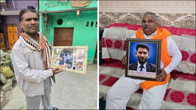 Man holding framed photos related to Delhi riots and Naxal activities.