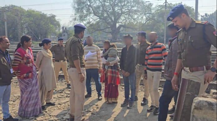 Child being rescued by authorities from trafficking gang, surrounded by police and villagers.