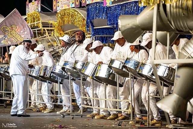 Group of drummers performing during a carnival celebration in the Bhartiya Diaspora, showcasing vibr.