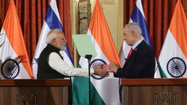 Image shows Indian Prime Minister Narendra Modi and Israeli President Isaac Herzog shaking hands dur.
