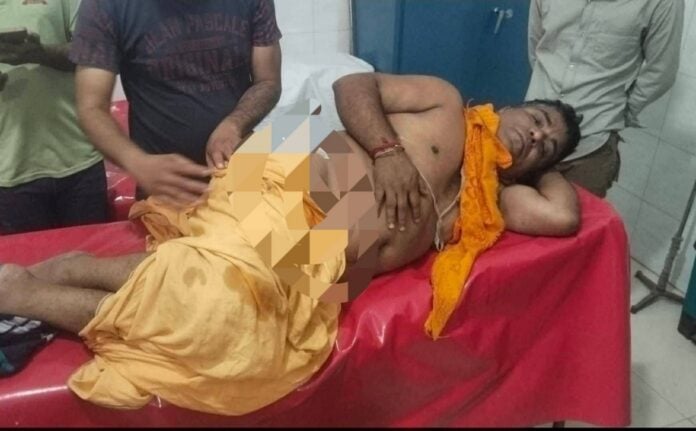 Image: An injured Hindu man receiving medical care in hospital