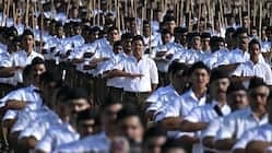 Students in white uniforms participating in school assembly in India.