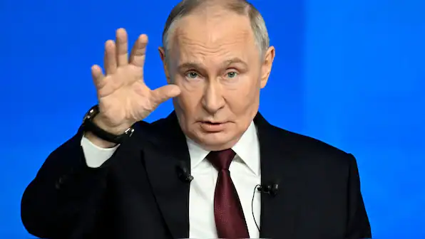 Russian leader Vladimir Putin gesturing during a speech, symbolizing Russia's involvement in intelli.