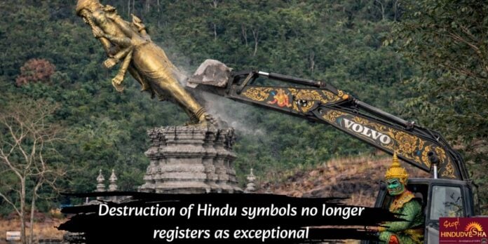 Close-up of a construction excavator damaging a Hindu statue symbolizing cultural loss.