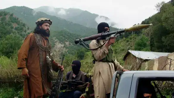 Armed militants with rocket launcher in Pakistan mountain region.