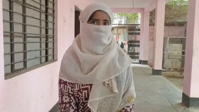 Woman wearing white hijab and face mask in a school corridor.