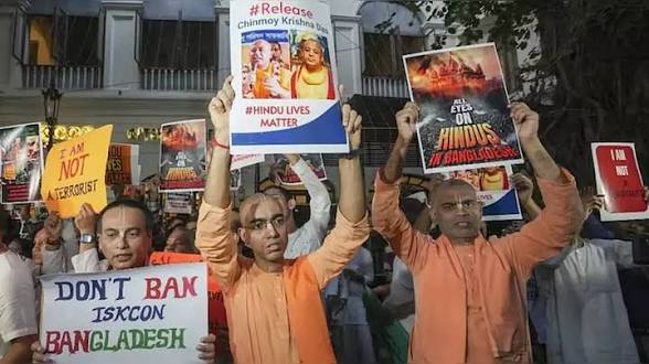 Protesters holding signs advocating for Hindu rights in Bangladesh during a demonstration.