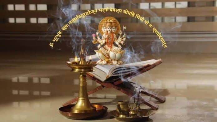 Ganesha idol with fire and scriptures for Hindu worship rituals.