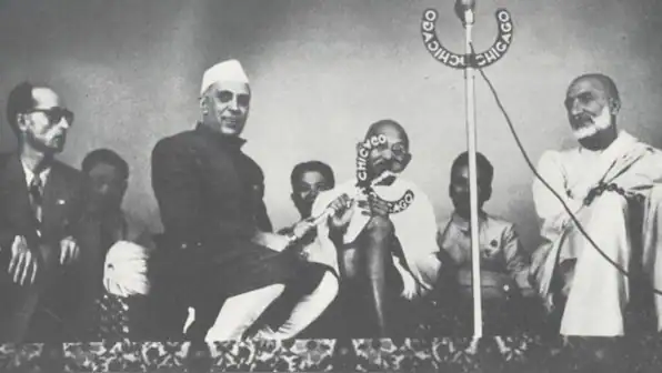 Nehru and Indian officials at a political event, discussing strategy and diplomacy.