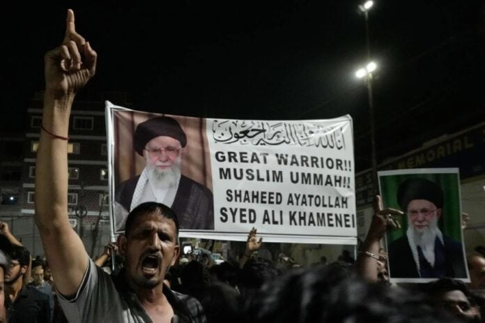 Protesters holding a banner and raising hands during rally against anti-nationals in India.
