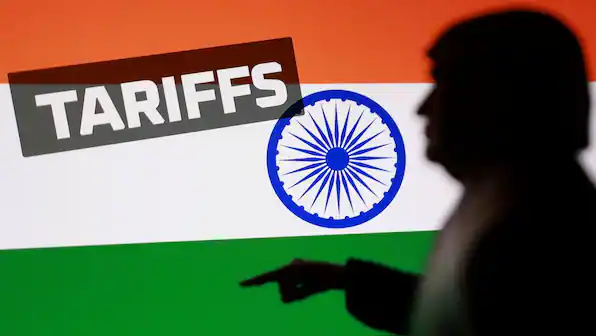 Silhouette of person pointing with Indian flag and tariffs sign, discussing US-India relations.