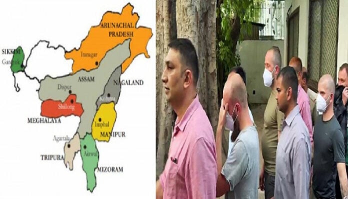 Group of men walking outdoors in North-East India, highlighting regional political issues.