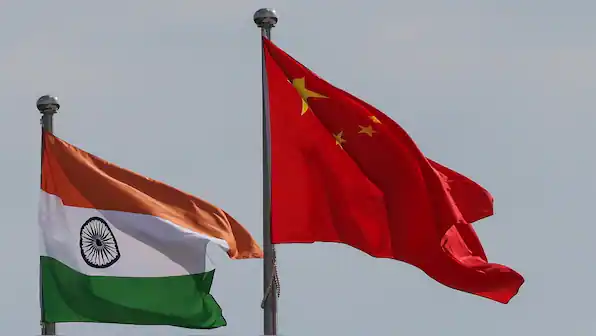Indian and Chinese flags flying in the wind, symbolizing border tensions.