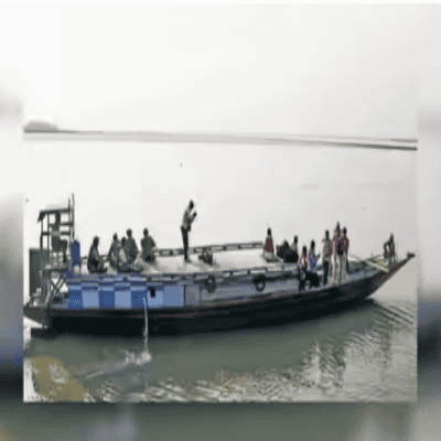 A boat carrying passengers on a calm river in Bharat, highlighting regional transportation initiativ.