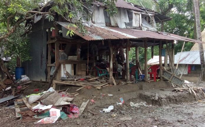 Hindu family house in Bagerhat damaged by armed Islamists during land dispute, showing destruction a.