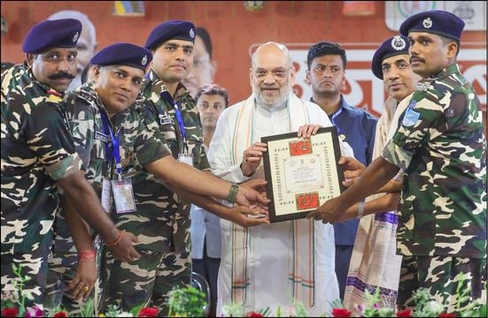 Indian Prime Minister Narendra Modi presenting award to military personnel at HinduPost event.