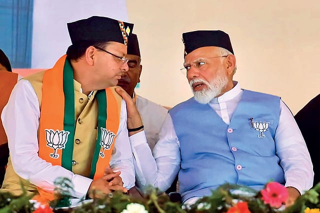 Indian politicians in traditional attire during a political meeting or event.