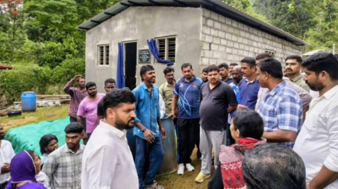 Group of people participating in a community meeting outdoors.