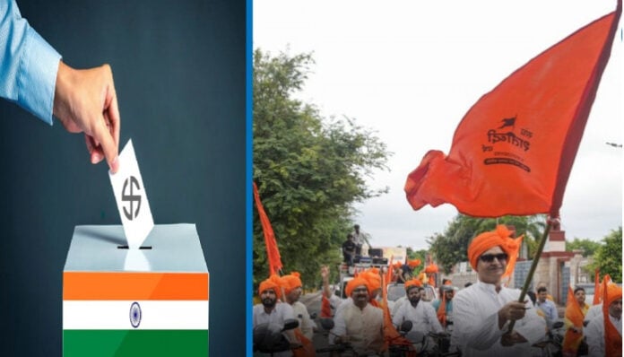 A group of Indian voters and political supporters with saffron flags during an election rally.