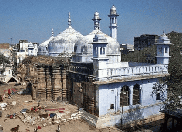 Historic Hindu temple with white domes, minarets, and traditional architecture in India.