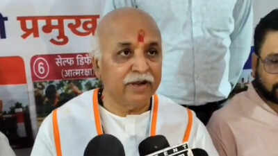 Hindu leader addressing media during a press conference, emphasizing cultural and religious issues.