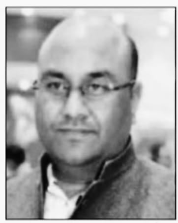 Portrait of Divya Agrawal, author and thinker, in black and white.