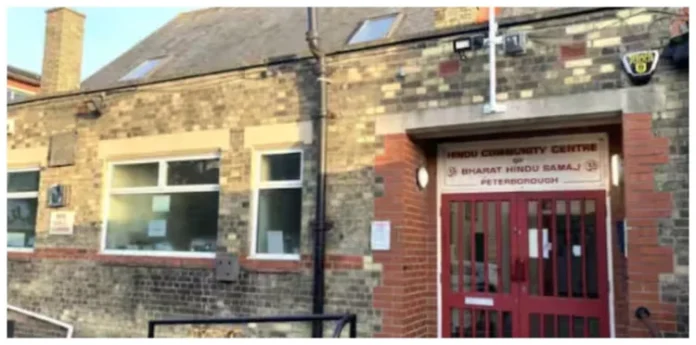 Hindu temple land sold for mosque in UK, community center building with red gate.
