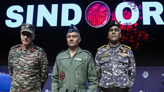Indian military officers in uniform at a formal event with 'SINDOR' sign in background.