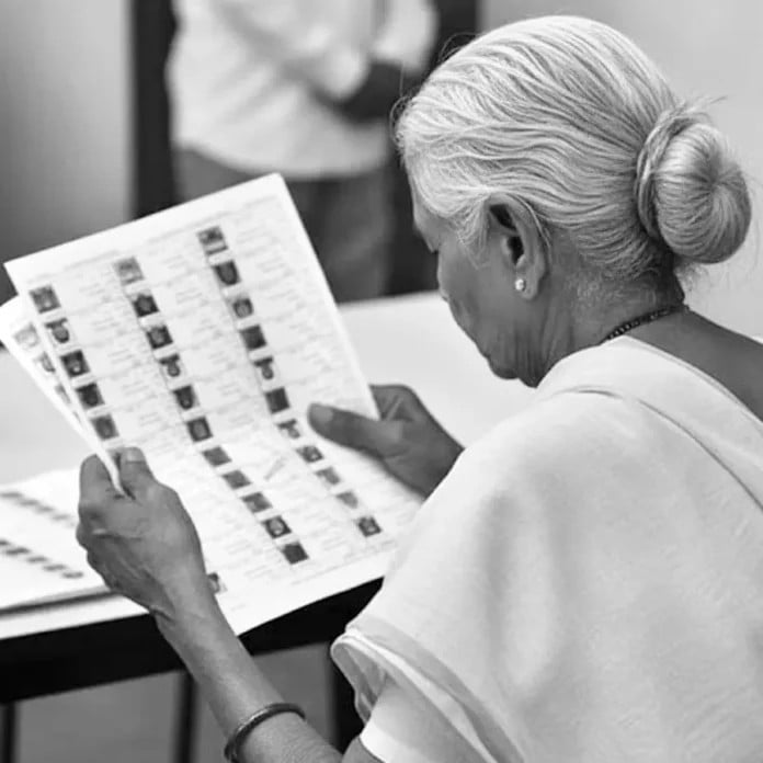 Senior woman reviewing ballot papers for voter verification and accuracy.